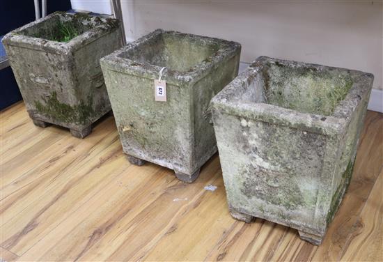 A set of three square shaped concrete gardens urns W.35cm approx.